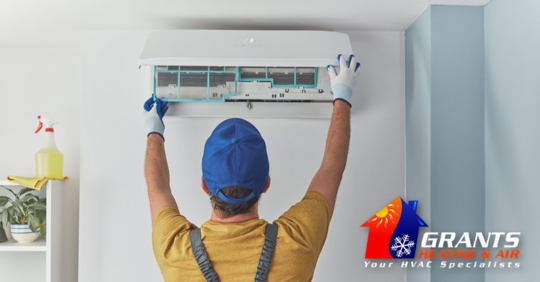 Repairman fixing AC unit